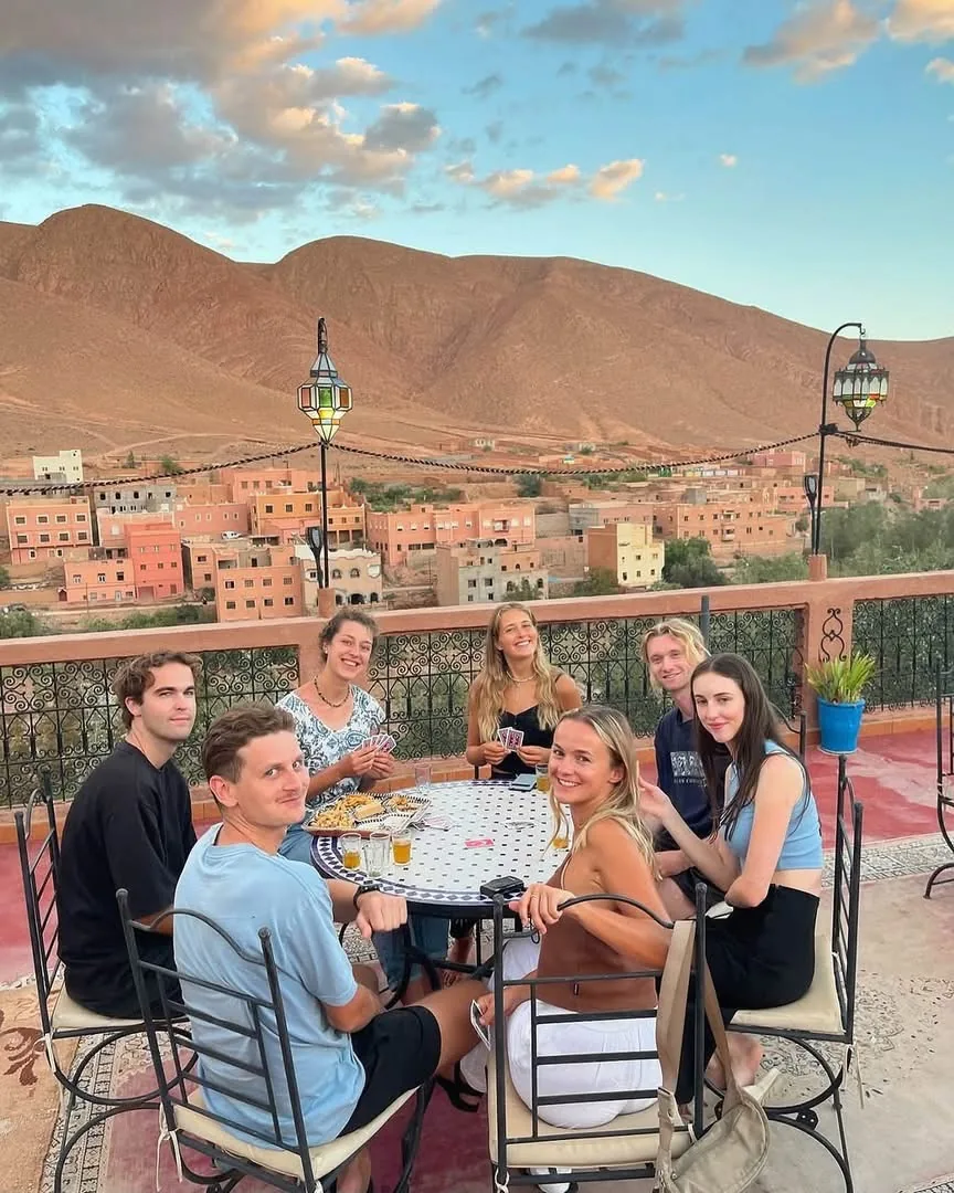 Dades Sunset Viewpoint: guests sharing tea on a terrace above an earthen dades valley village